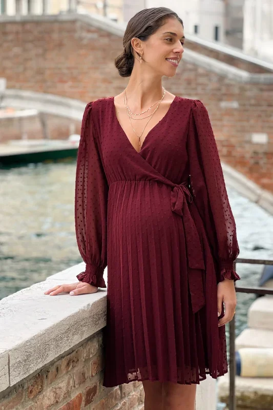 Festive maternity dress in a wrap style with a pleated skirt in burgundy
